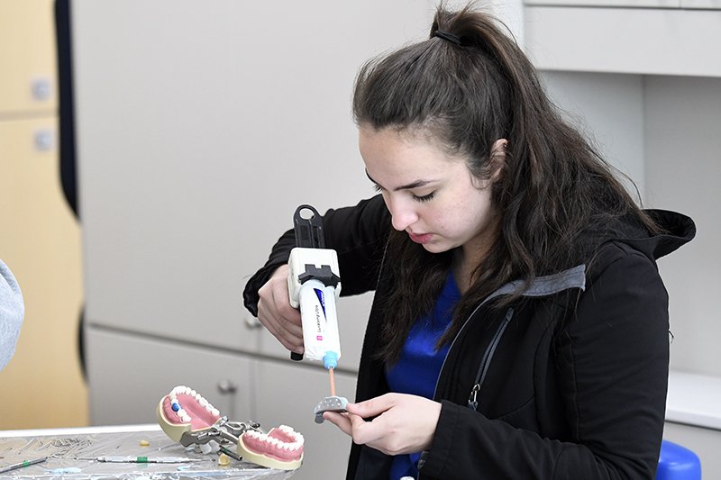 dental assisting student working on a model