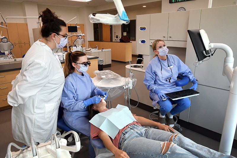 dental hygiene students with instructor