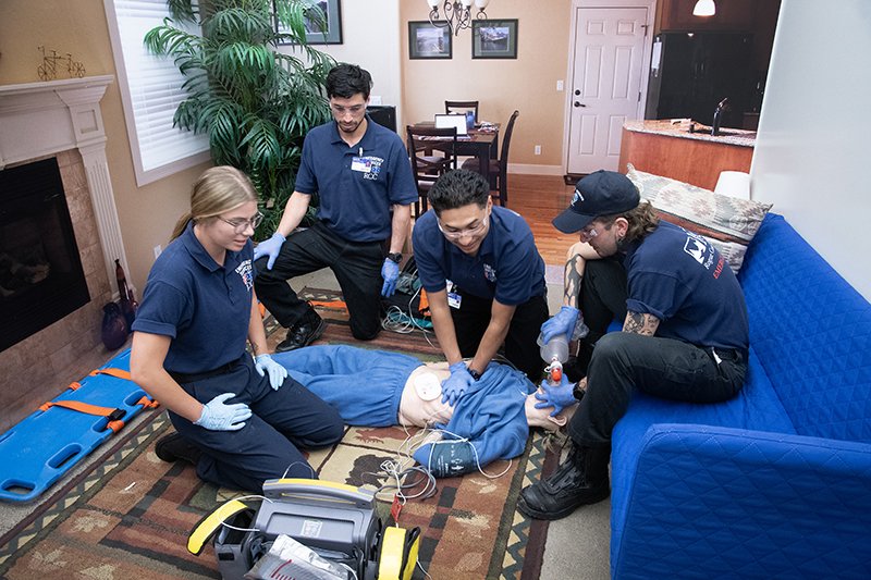 EMS students looking over a patient