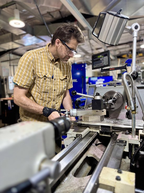 student using manufacturing equipment