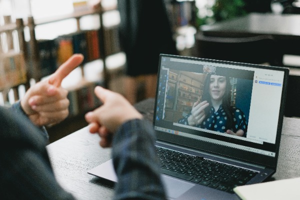 a student using ASL on a computer meeting